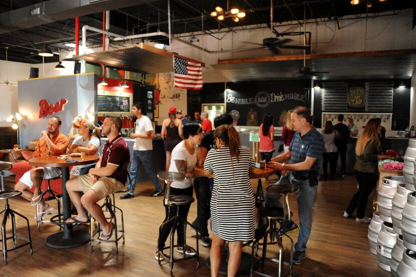 Friends enjoy beer and relaxing in the tap room at the Zero Anniversary party at Noble Rey...