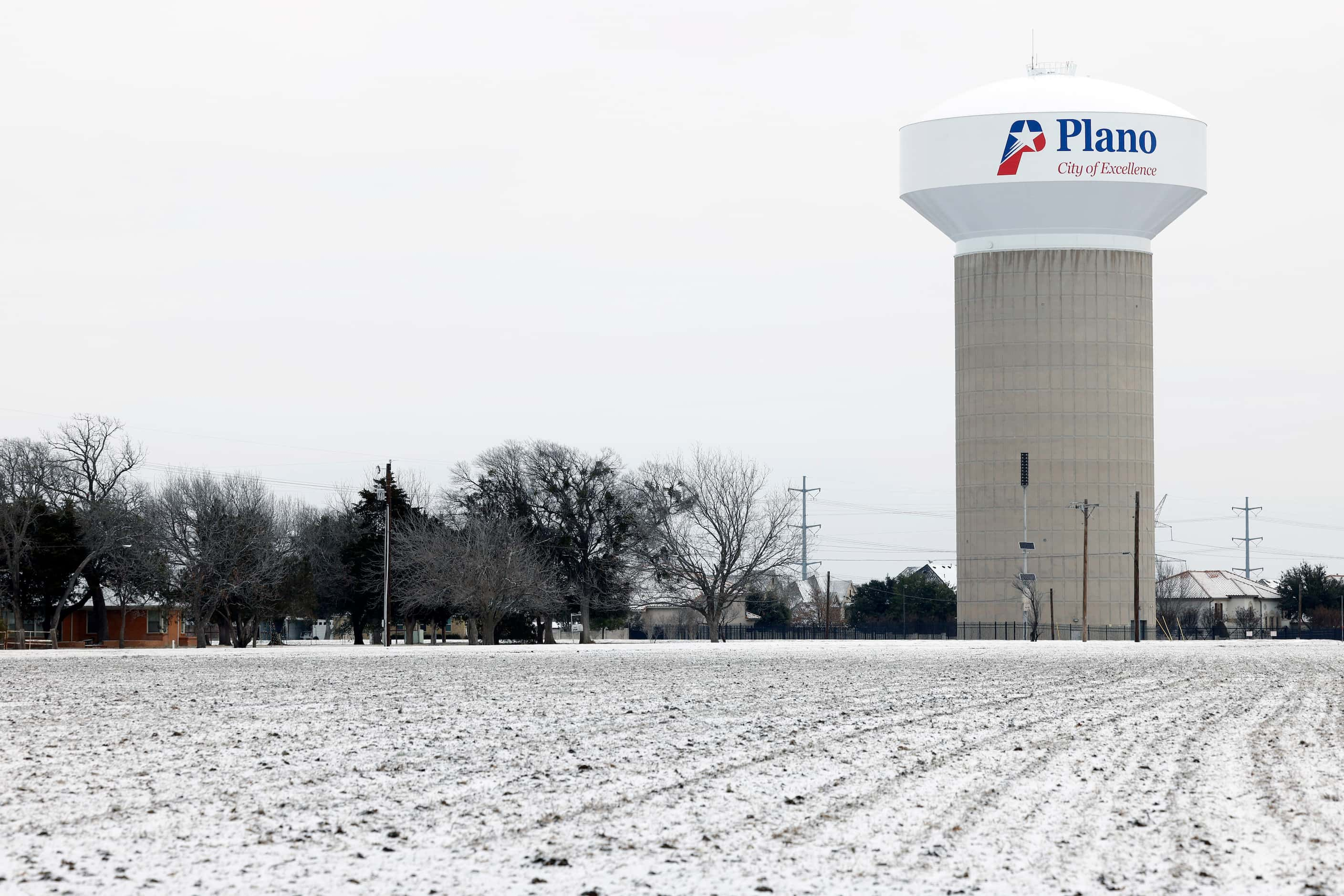 Snow covers the ground in a field near a water tower, Monday, Jan. 15, 2024, in Plano,...