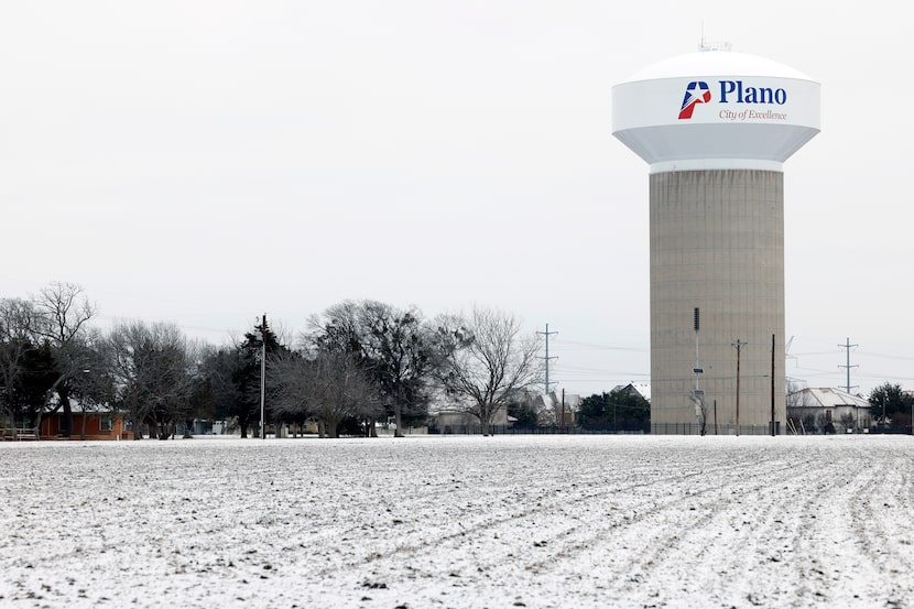 Snow covers the ground in a field near a water tower, Monday, Jan. 15, 2024, in Plano,...