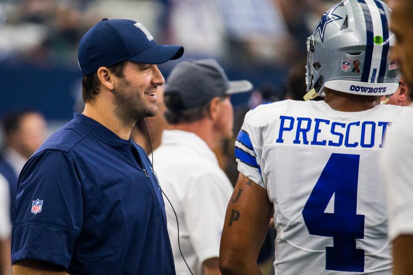 FILE - Cowboys quarterback Tony Romo (9) talks to quarterback Dak Prescott (4) on the...