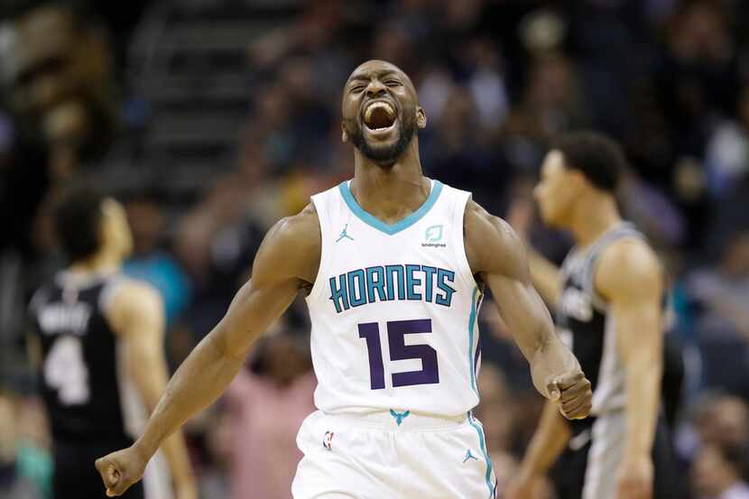 FILE - In this March 26, 2019, file photo, Charlotte Hornets' Kemba Walker (15) reacts after...