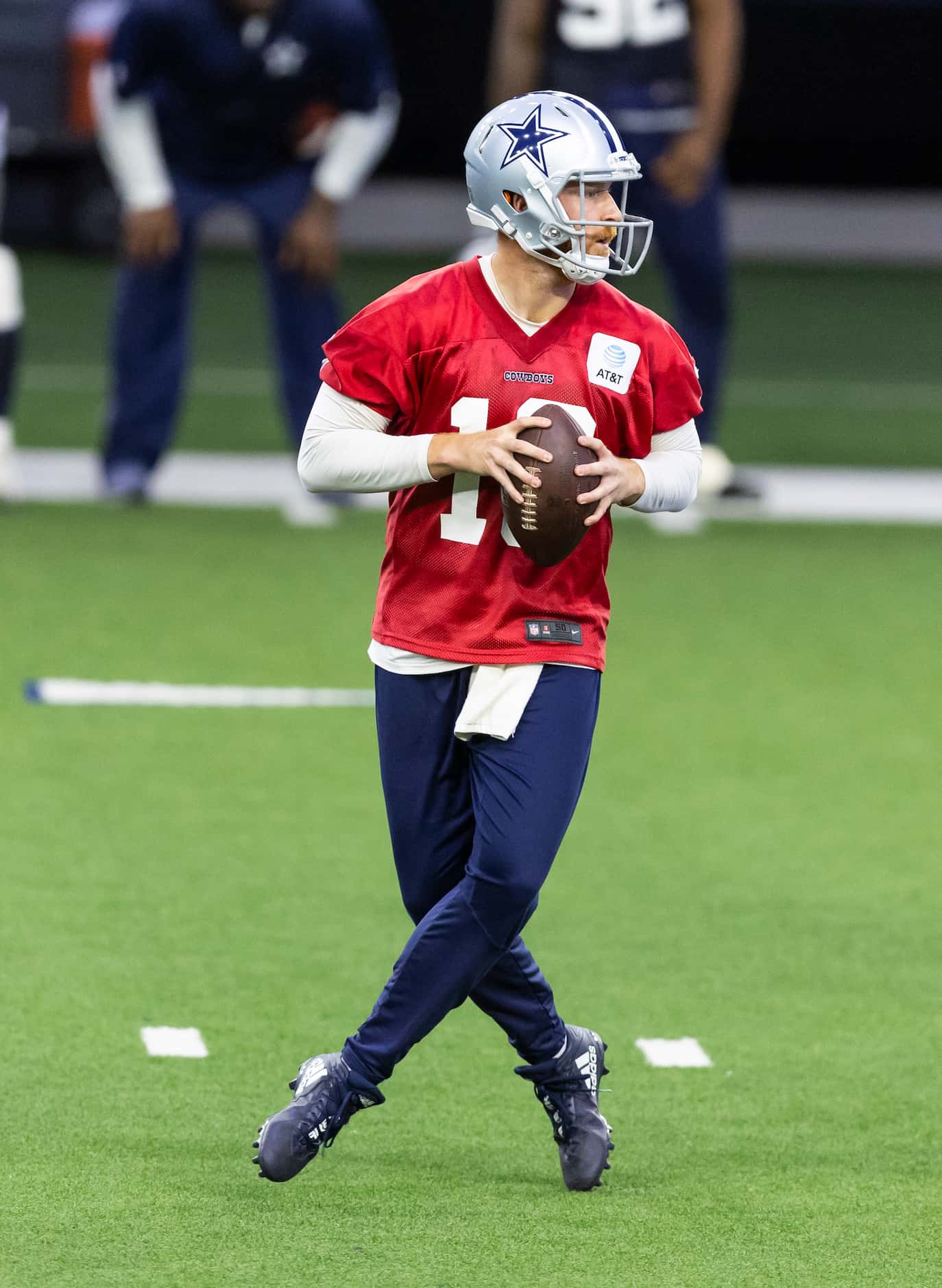 Dallas Cowboys quarterback Cooper Rush looks for an open receiver during a minicamp practice...