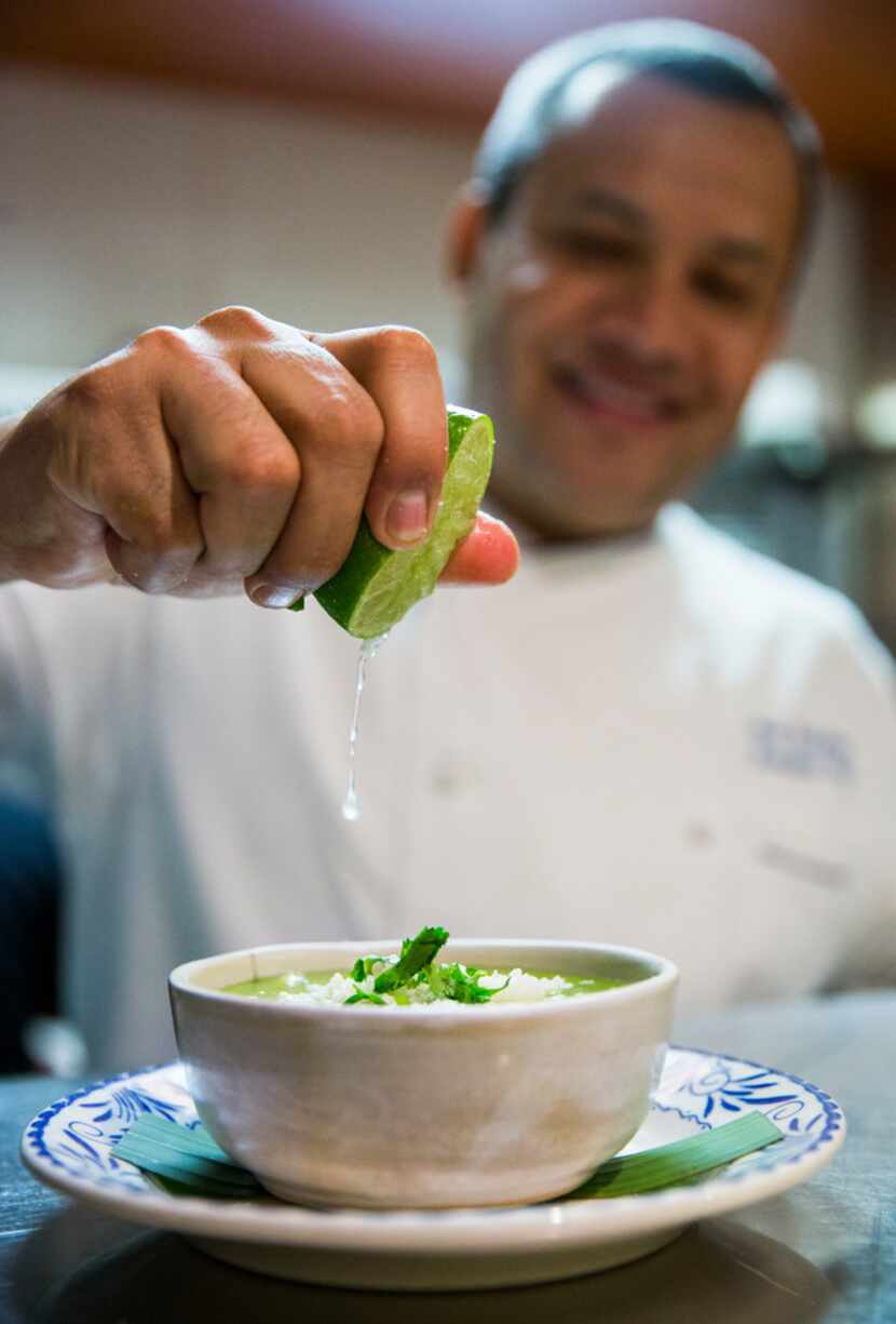 Chef Nico Sanchez squeezes lime juice on top of a bowl of his pozole verde at Mesa Maya.