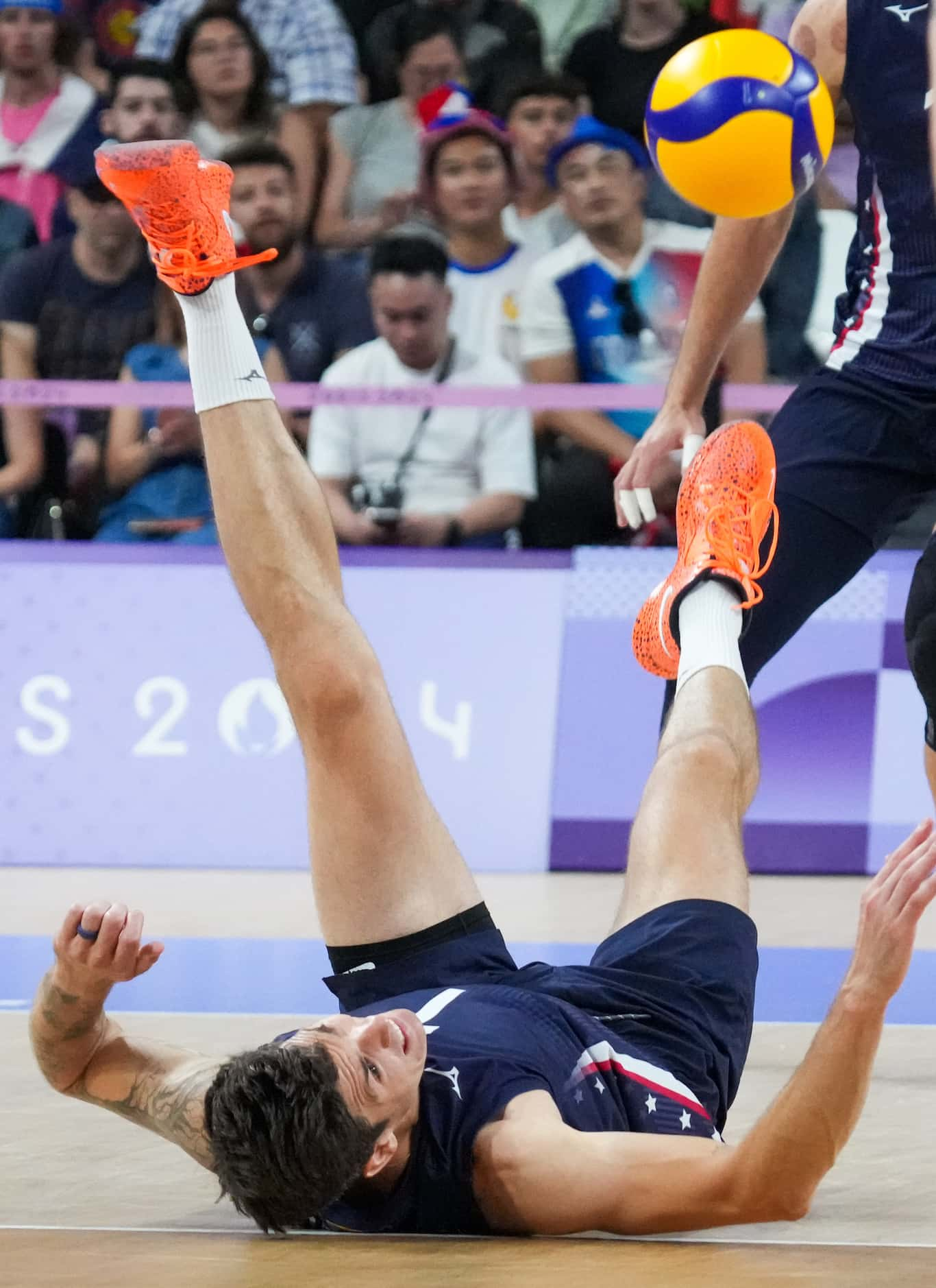 Matthew Anderson (1) of the United States tumbles trying to make a play during a men’s...