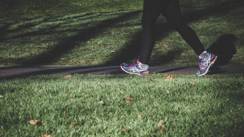 person in black leggings running in the park