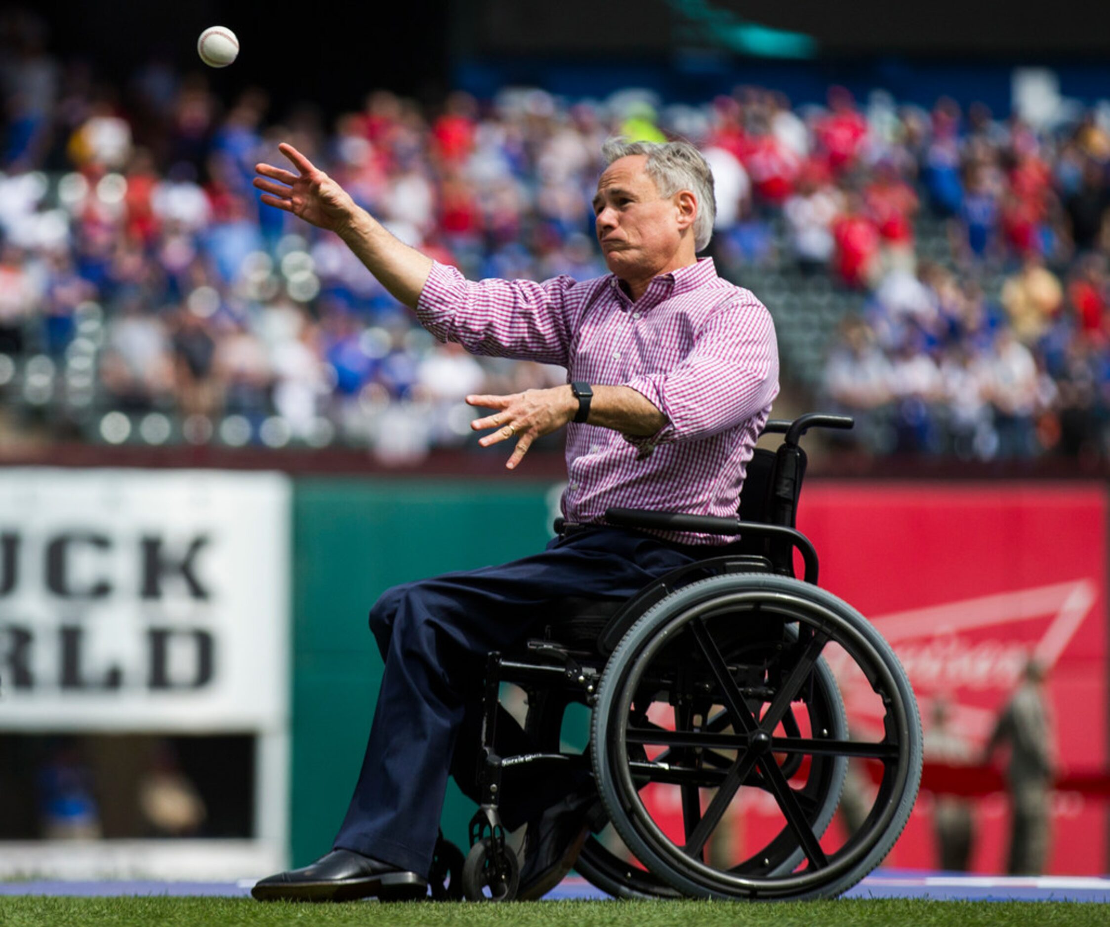 Texas Governor Greg Abbott throws the first pitch before an opening day MLB game between the...