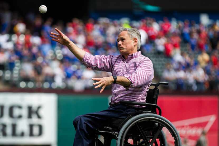 Gov. Greg Abbott, shown tossing the first pitch at 2019's opening day game between the Texas...