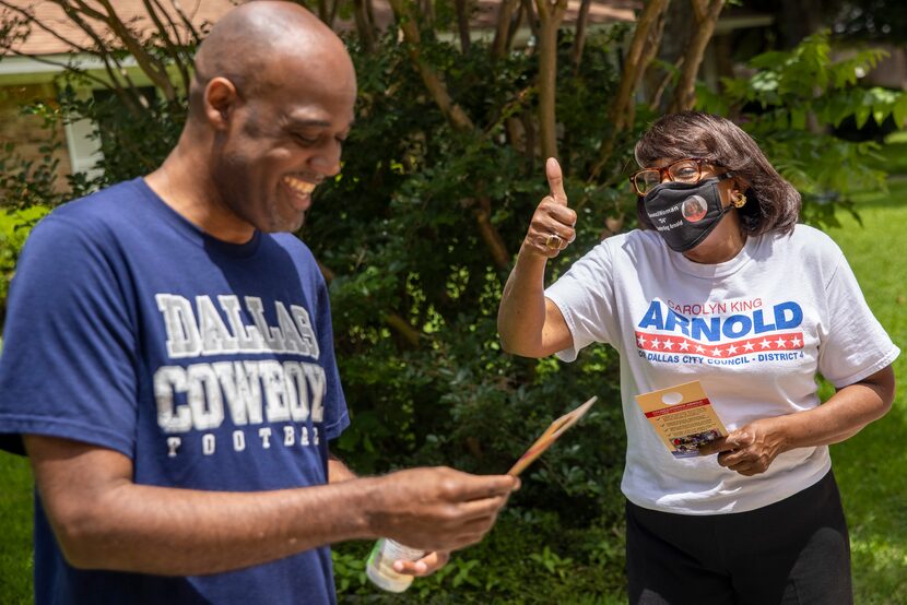 City councilwoman Carolyn King Arnold, right, speaks with Daniel Banks about about the...