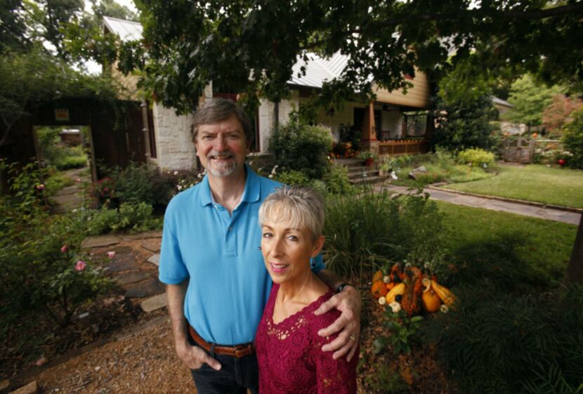 Rob and Suzy Renz pose for a portrait in their front yard garden at their home in Dallas on...