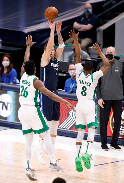 Dallas Mavericks guard Luka Doncic (77) takes the game-winning shot over Boston Celtics...