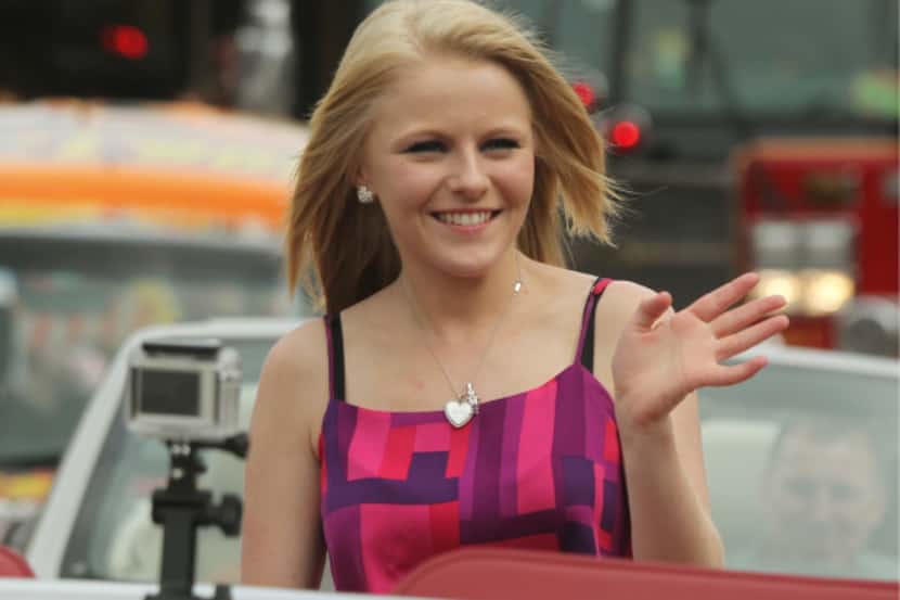 "American Idol"finalist Hollie Cavanagh waves to the crowd as a parade held in her honor...