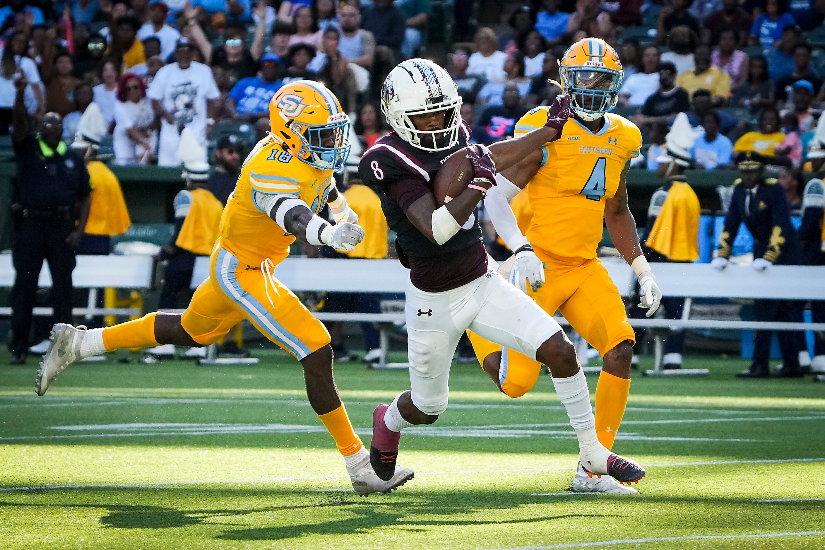 TSU wide receiver Derek Morton (8) gets past Southern  defenders Tyler Judson (18) and Benny...