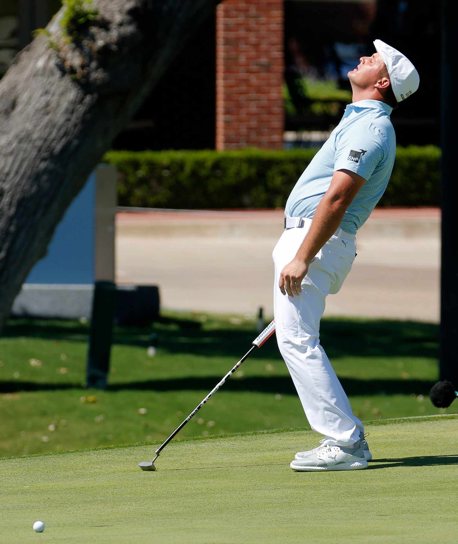 PGA Tour golfer Bryson DeChambeau
reacts after missing a birdie putt on No. 18 leaving him...