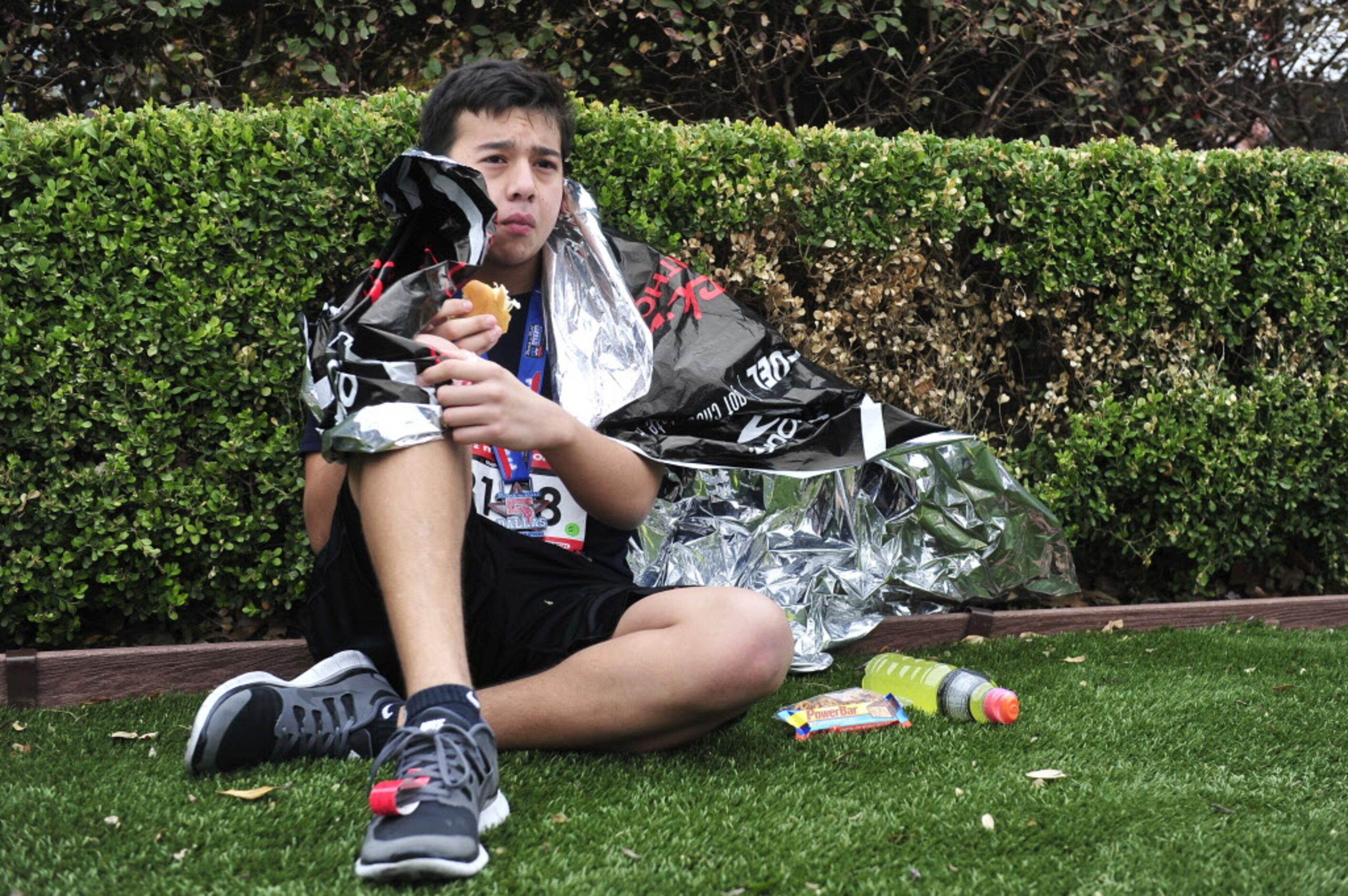 Christopher Martinez eats a hot dog after finishing the Dallas Rock N' Roll half-marathon on...