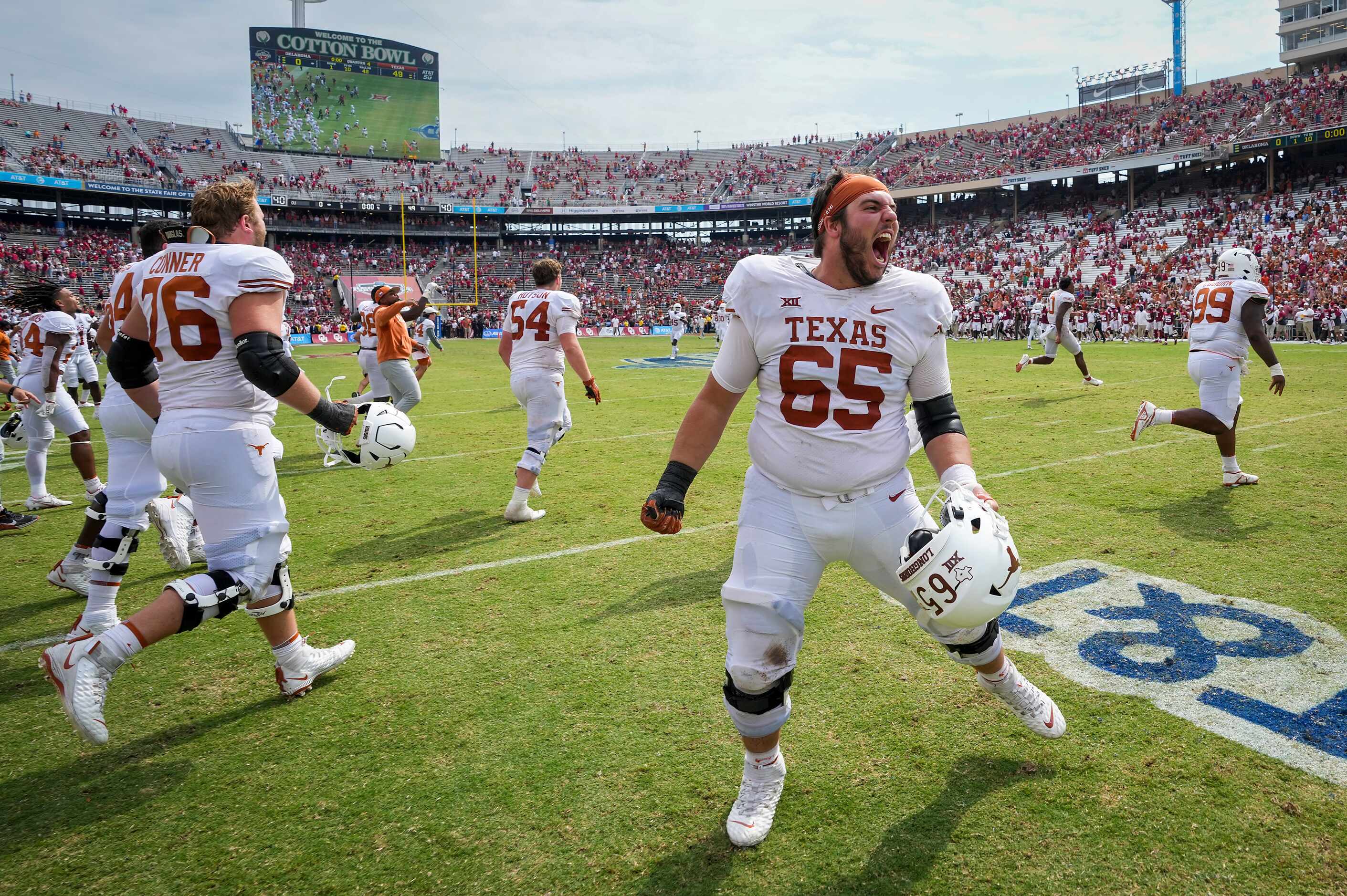 Texas offensive lineman Jake Majors (65) celebrates with teammates after a victory over...
