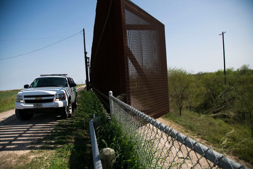 A Border Patrol vehicle guards a section of border fence in Runn, Texas, in March. (Kelly...