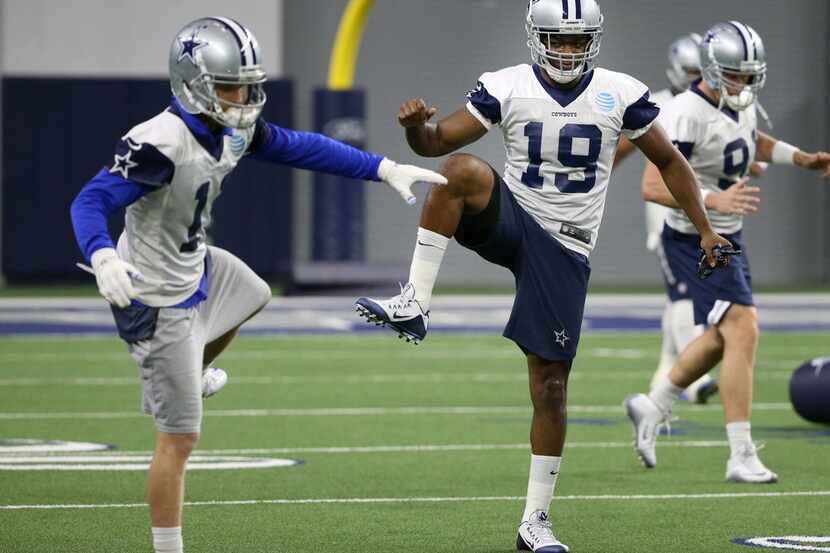 Dallas Cowboys receiver Amari Cooper (19)  stretches alongside Dallas Cowboys wide receiver...