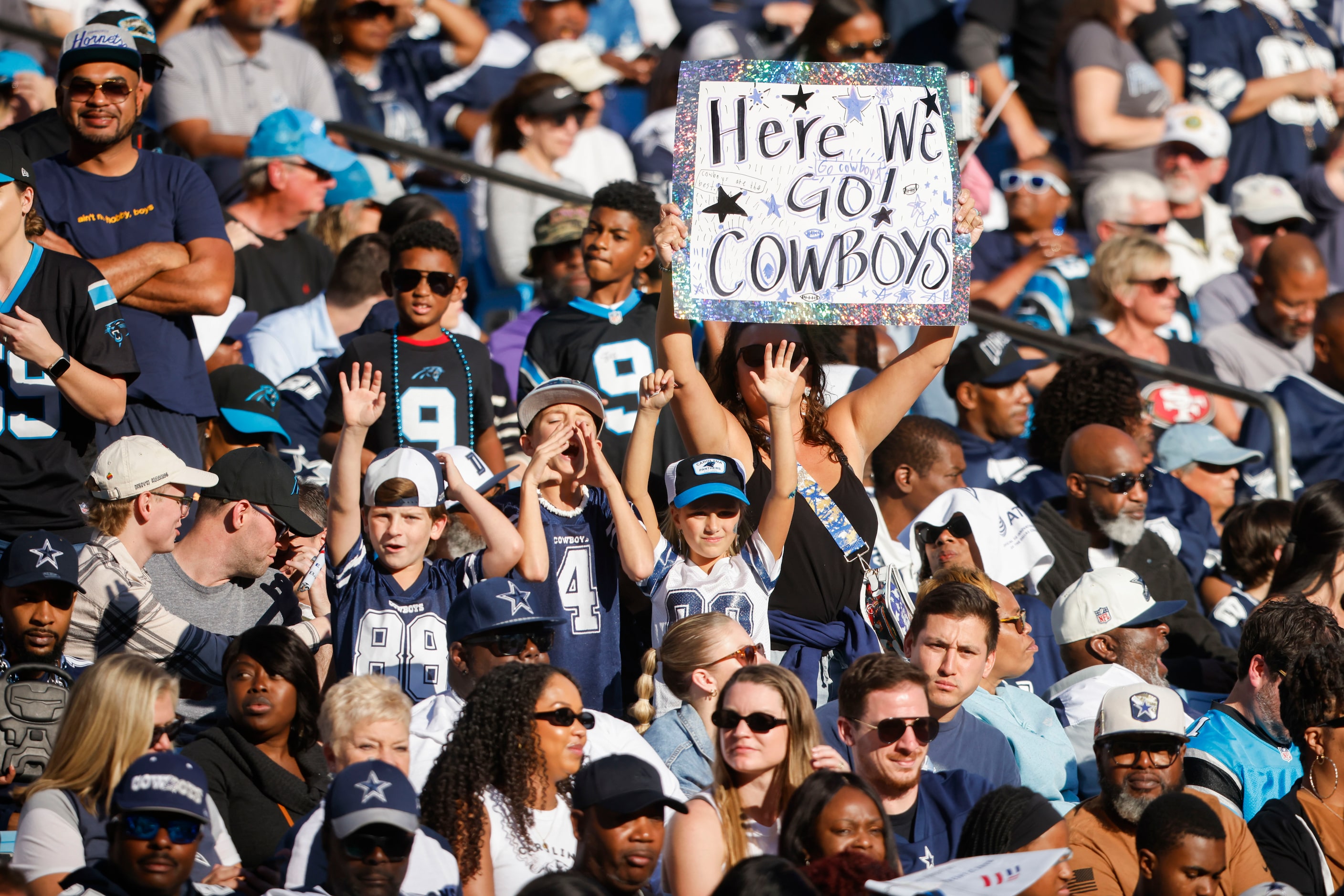 Dallas Cowboys fans celebrate during the fourth quarter of a NFL game against the Carolina...