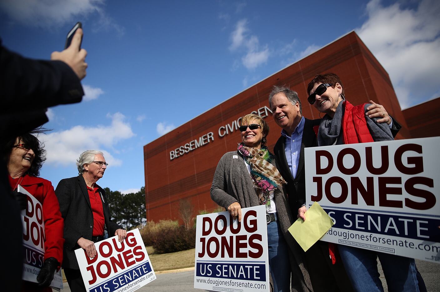 Doug Jones mingled with voters outside a polling station in Bessemer, Ala., on Tuesday. 