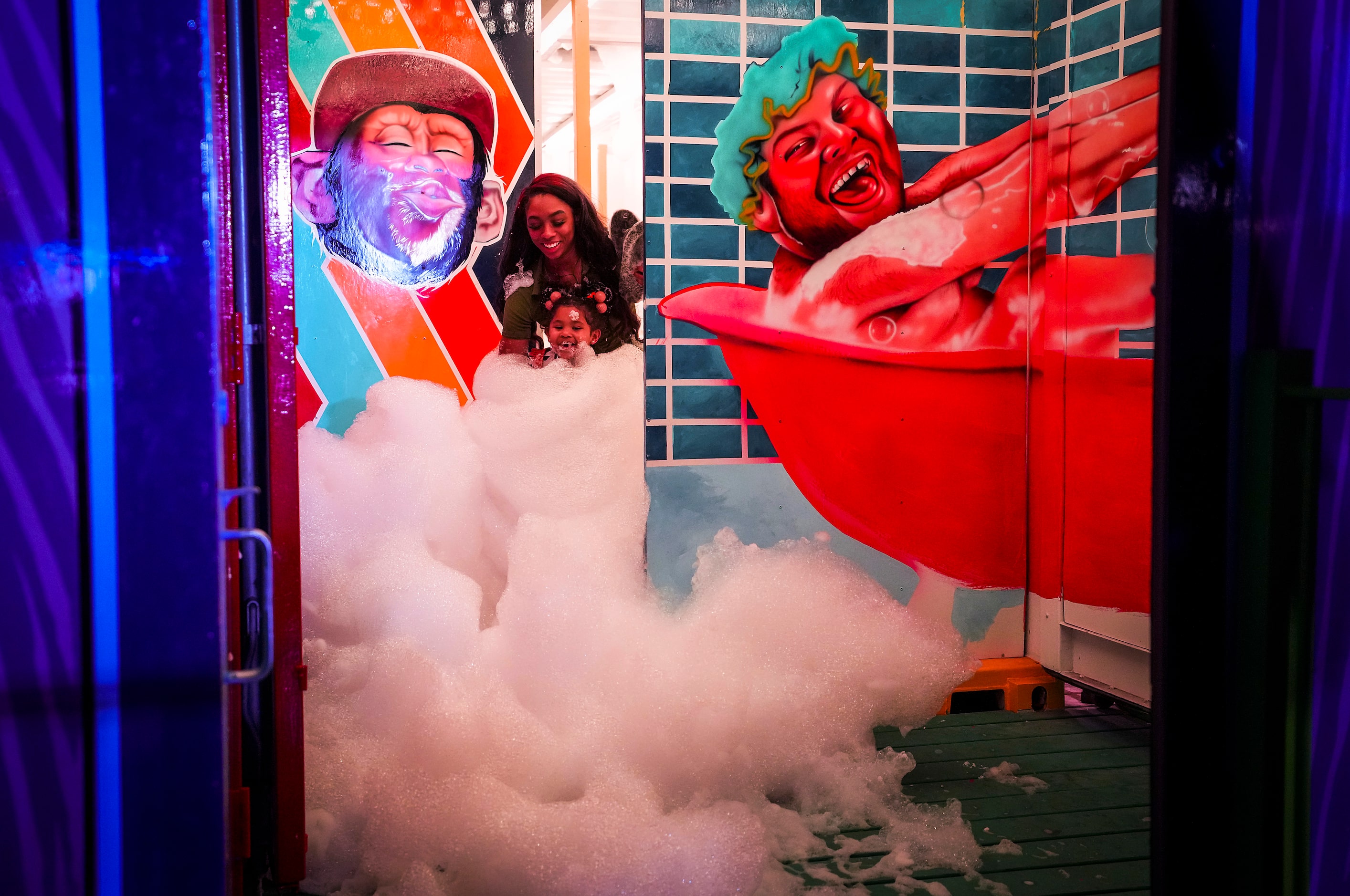 Davia Maldonado of Fort Worth plays in soap bubbles with her daughter Malon, 3, in a...