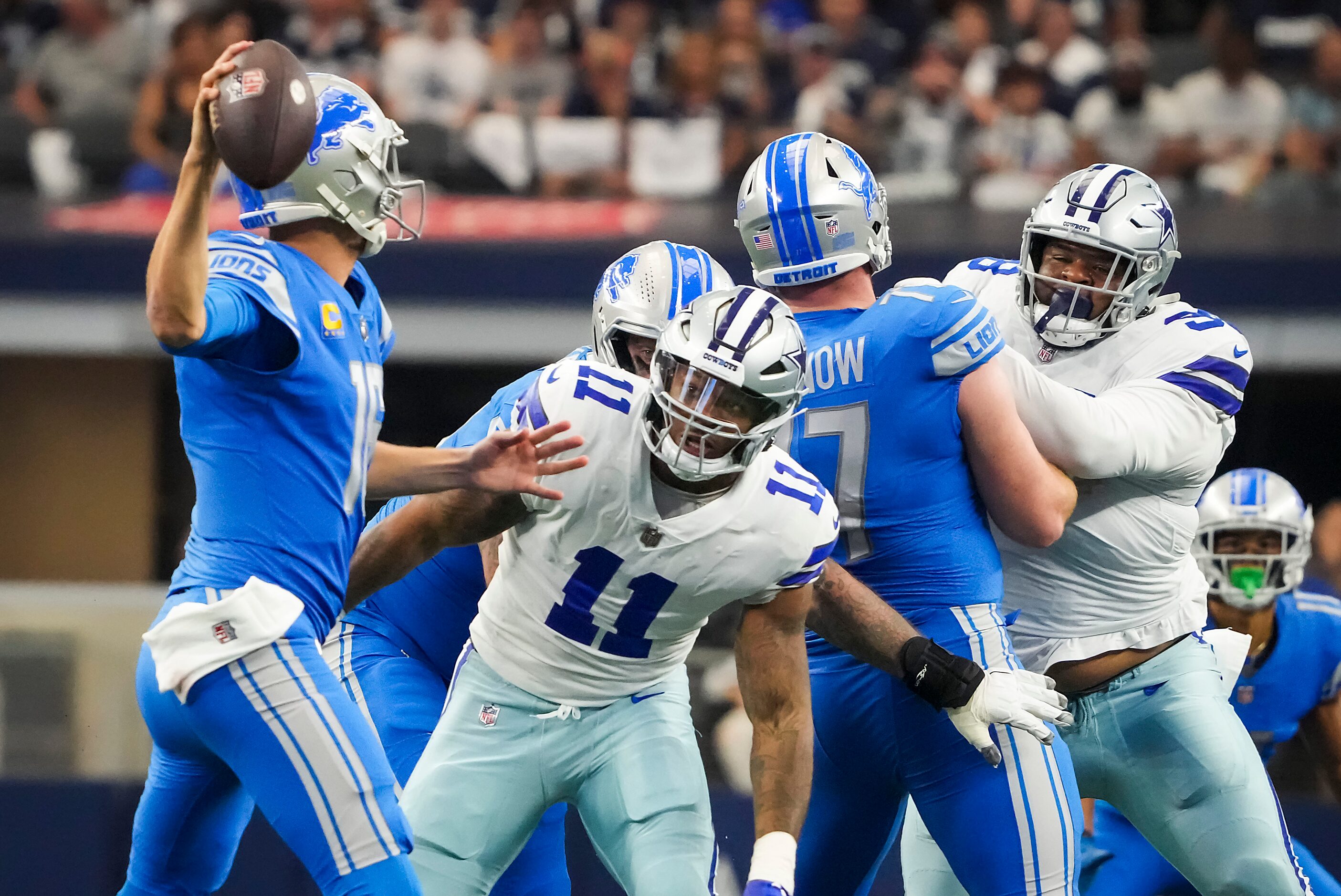 Detroit Lions quarterback Jared Goff (16) passes under pressure from Dallas Cowboys...