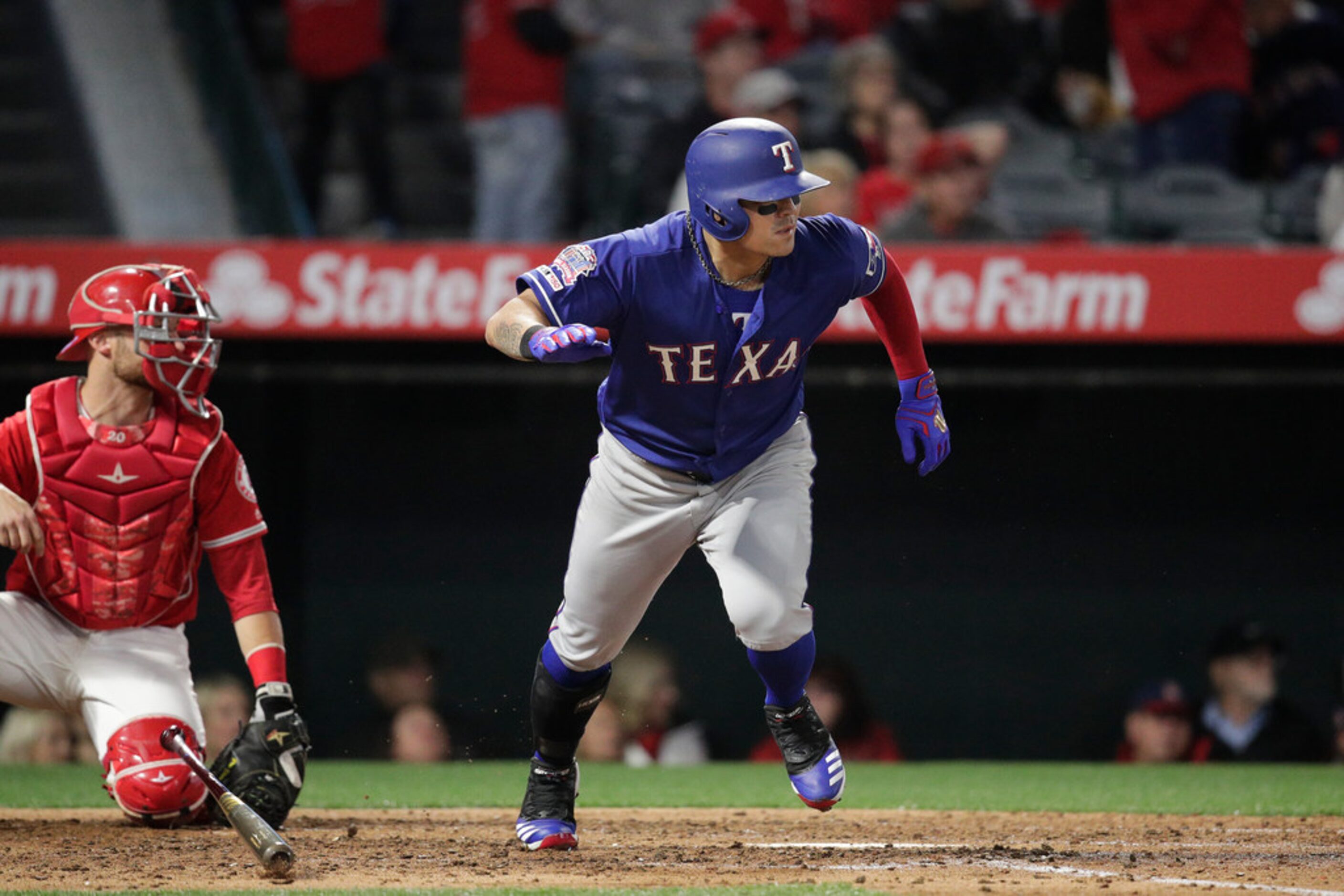 Texas Rangers' Shin-Soo Choo, of South Korea, heads to first with a single during the fifth...