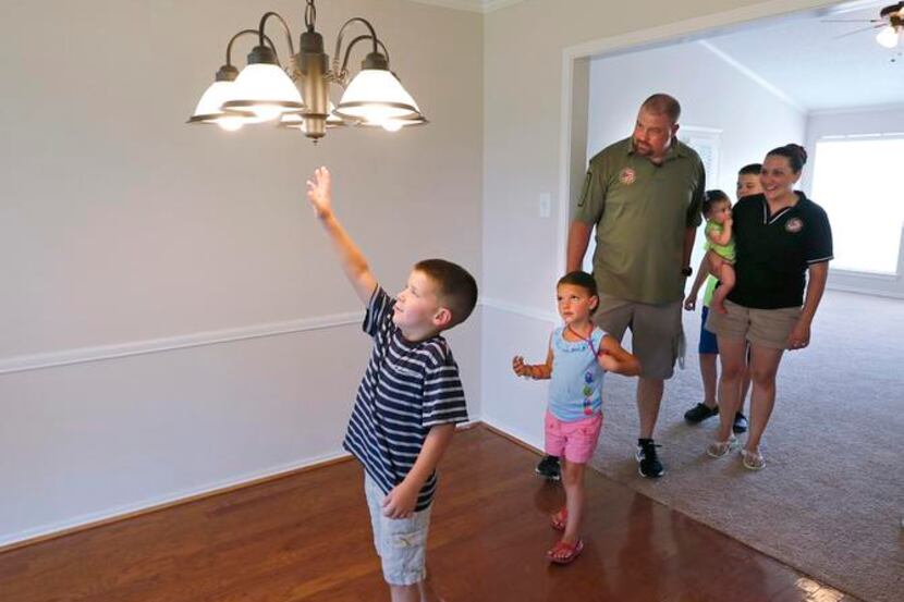 
Touring their new home are Justin Lynn, wife Gabrielle, holding Emmie, and Drew, Abigail...