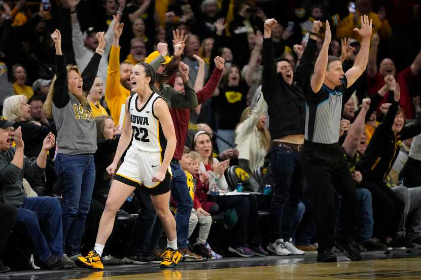 Iowa guard Caitlin Clark (22) reacts after breaking the NCAA women's career scoring record...