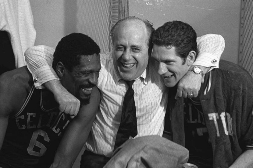 Boston Celtics general manager Red Auerbach hugs the stars of the Celtics NBA Championship...