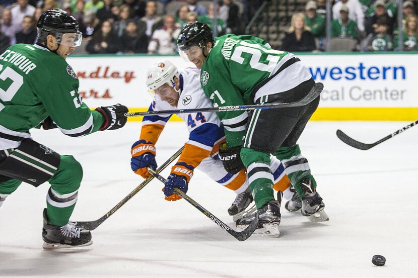 New York Islanders defenseman Calvin de Haan (44) is tied up by Dallas Stars left wing...