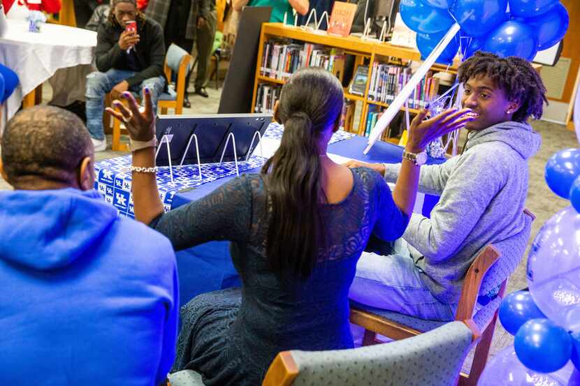 Tyrese Maxey looks over his parents after signing his letter of intent to play basketball at...