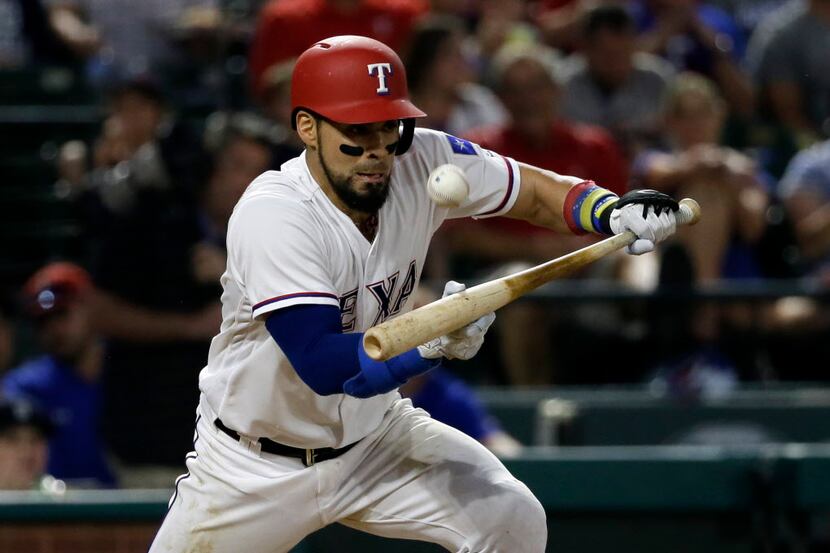 Texas Rangers' Robinson Chirinos lays down a sacrifice bunt that moved Rougned Odor from...