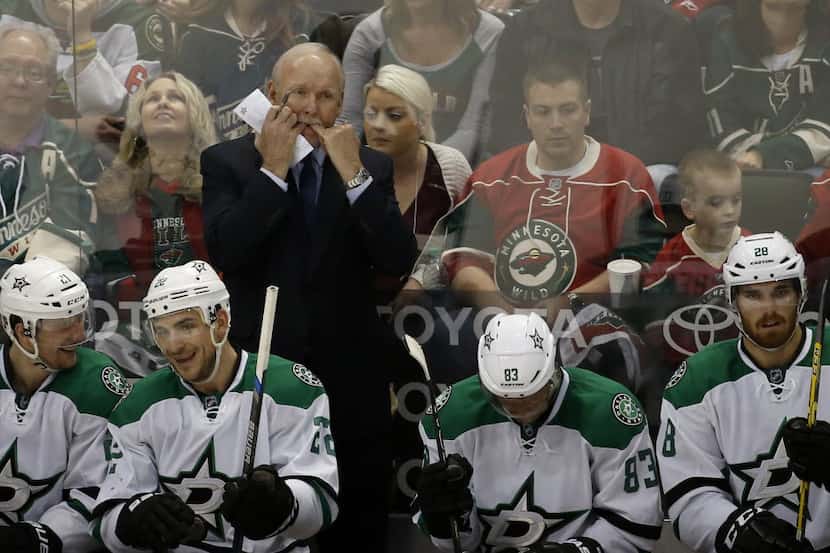 Dallas Stars head coach Lindy Ruff, top, whistles to his players during the second period of...