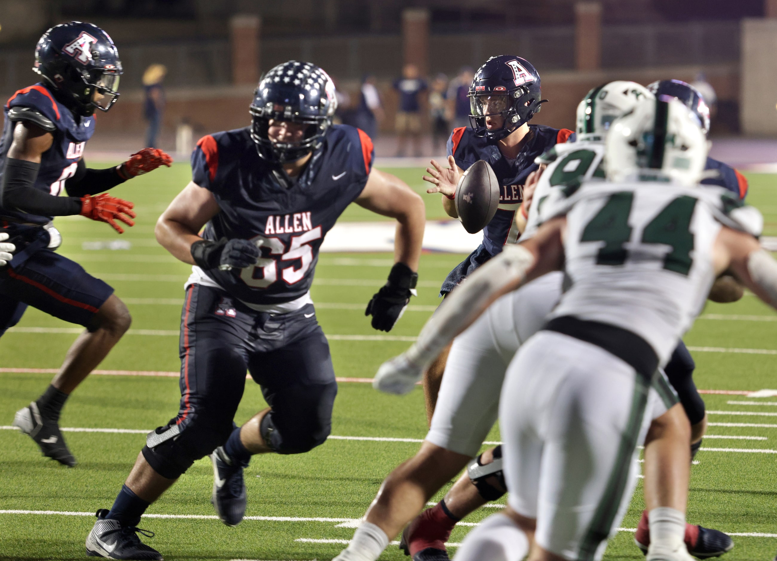 Allen player #7 Brady Bricker receives the snap during the Prosper High School at Allen High...