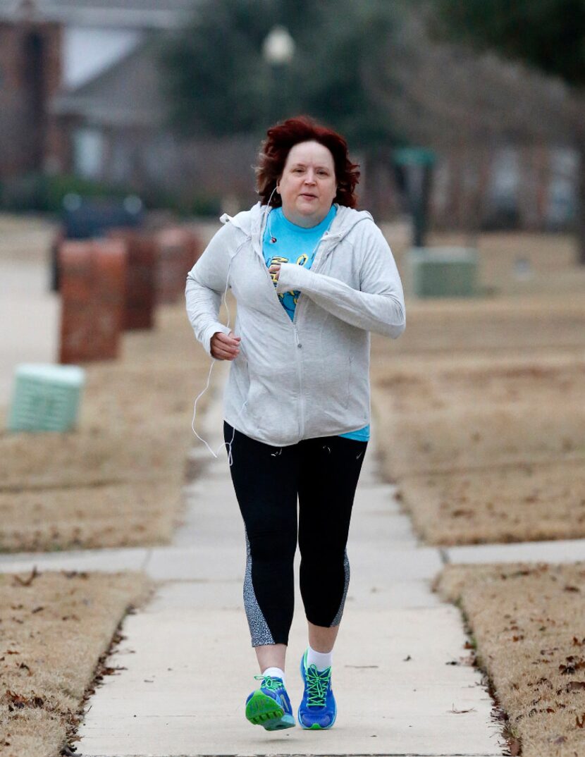 Cathy Murdoch runs through her neighborhood in Murphy to prepare for an upcoming half...