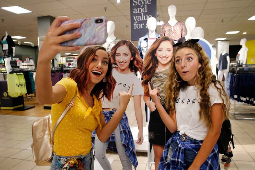 Twin sisters Bailey (left) and Brooklyn McKnight take a selfie inside J.C. Penney at Collin...