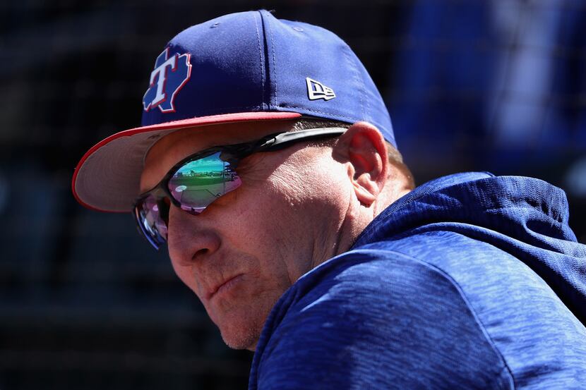 SURPRISE, AZ - MARCH 05:  Manager Jeff Banister #28 of the Texas Rangers watches from the...