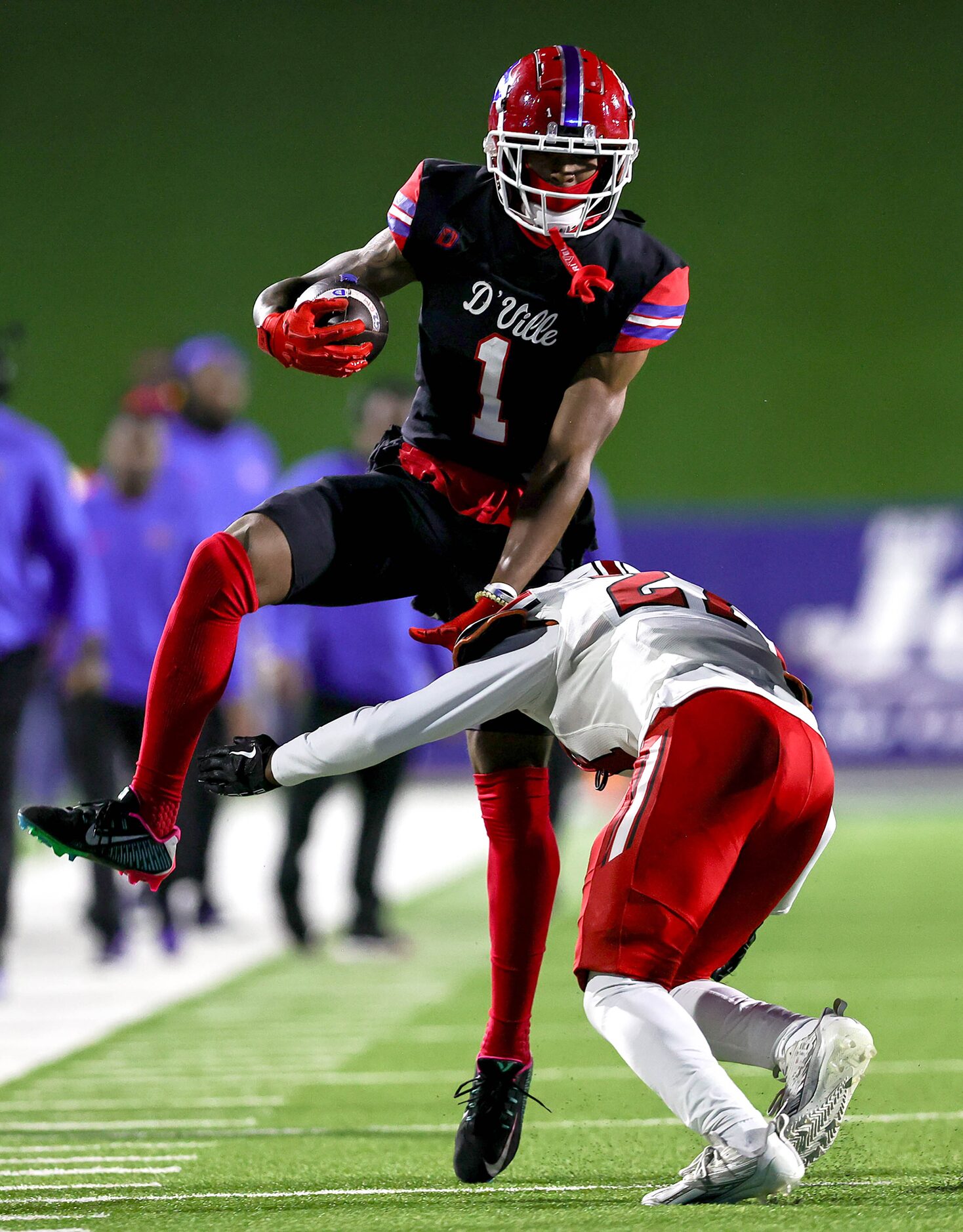 Duncanville wide receiver Dakorien Moore (1) tries to leap over Rockwall Heath safety Jordan...