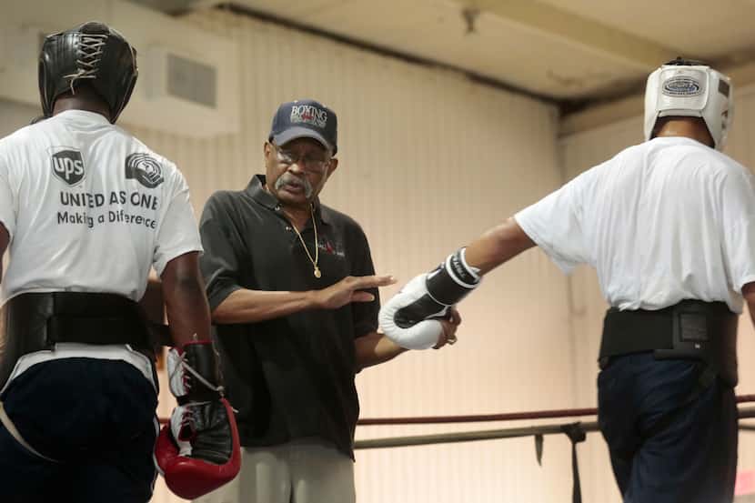 Curtis Cokes. 76, as former boxing champion from Dallas, Texas, trains firghter at his gym...