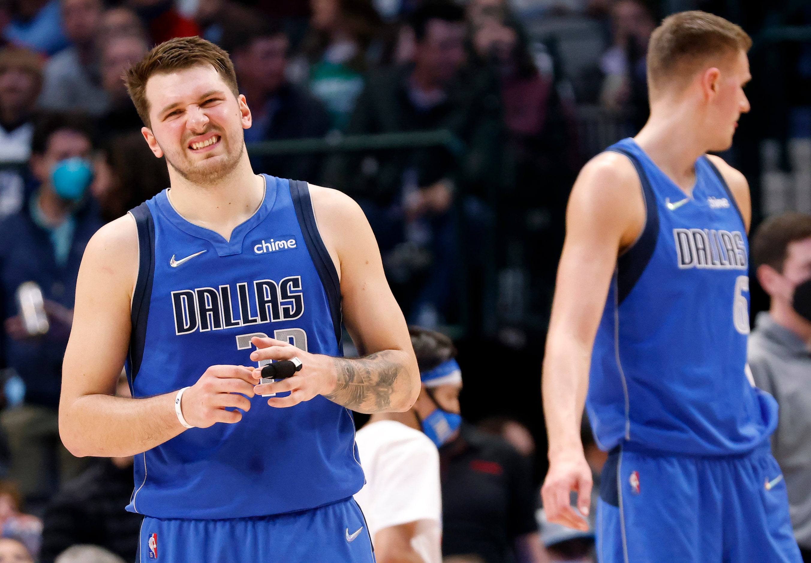 Dallas Mavericks guard Luka Doncic (77) adjusts the bandage on his index finger during the...