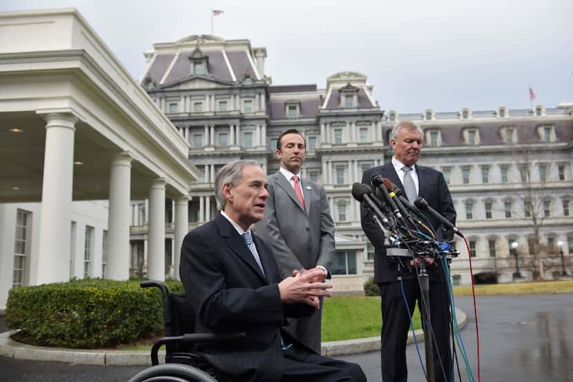 Texas Gov Greg Abbott speaks to reporters outside the West Wing of the White House, along...
