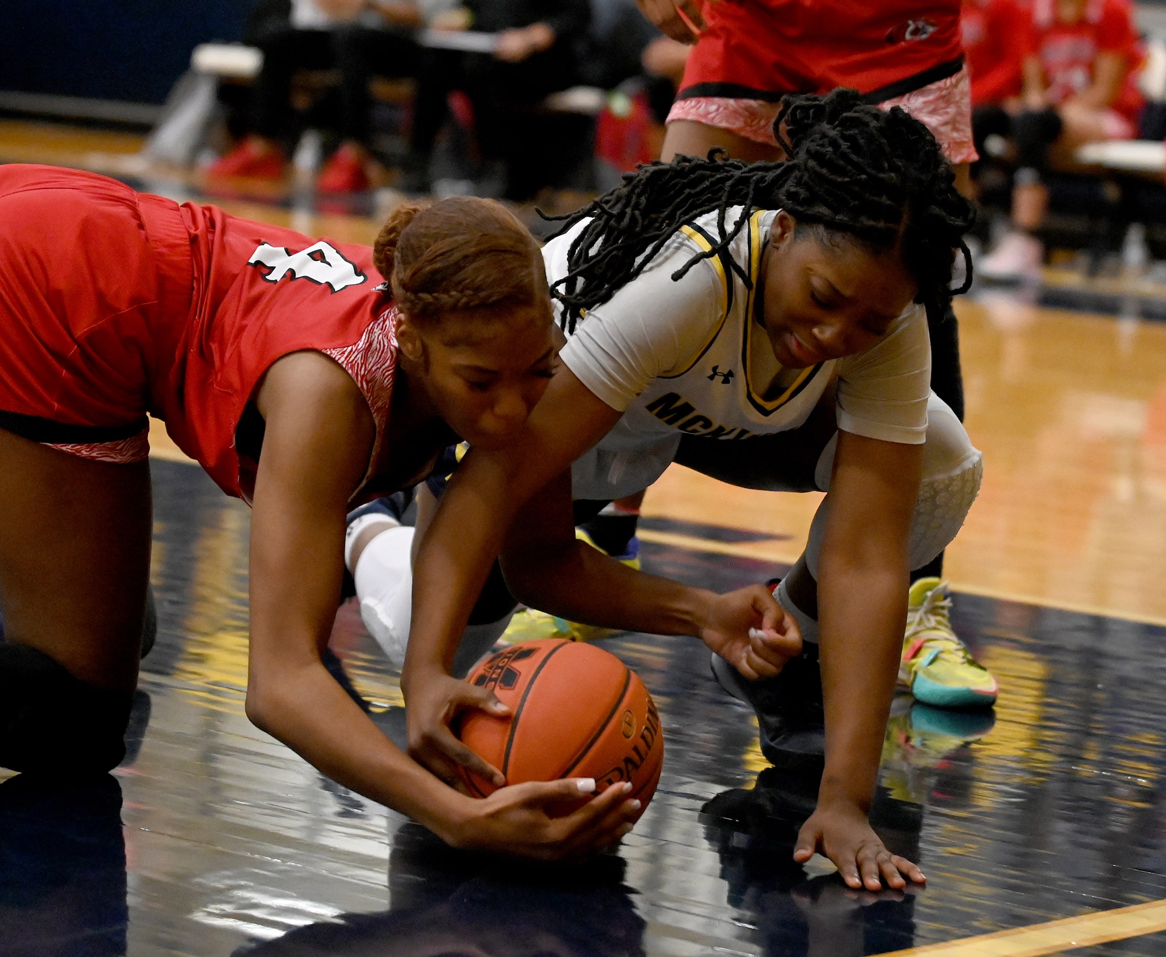 Braswell’s Kennedy Evans (4) and McKinney’s Kim Gordon (40) go after a loose ball in the...