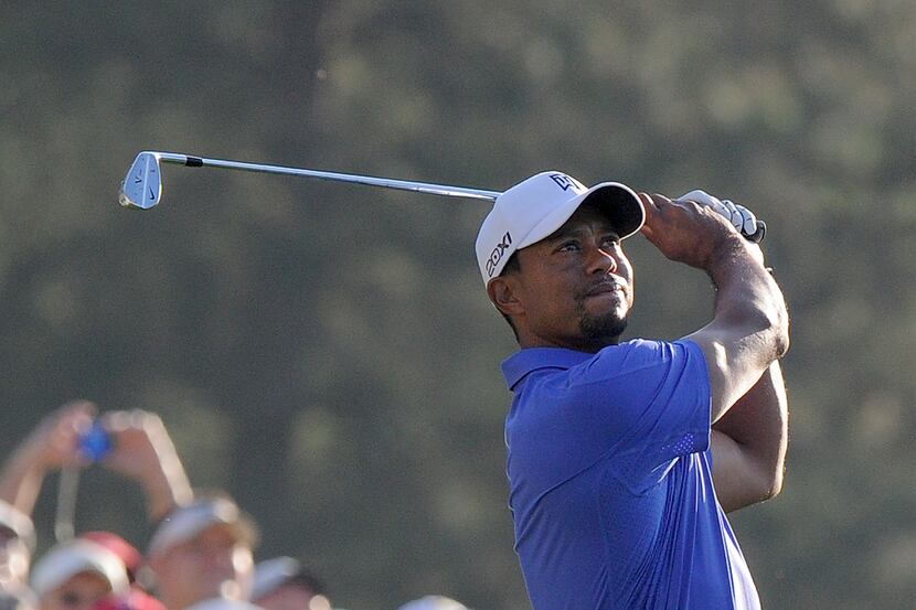 Tiger Woods of the US hits a shot during a practice round at the 77th Masters golf...