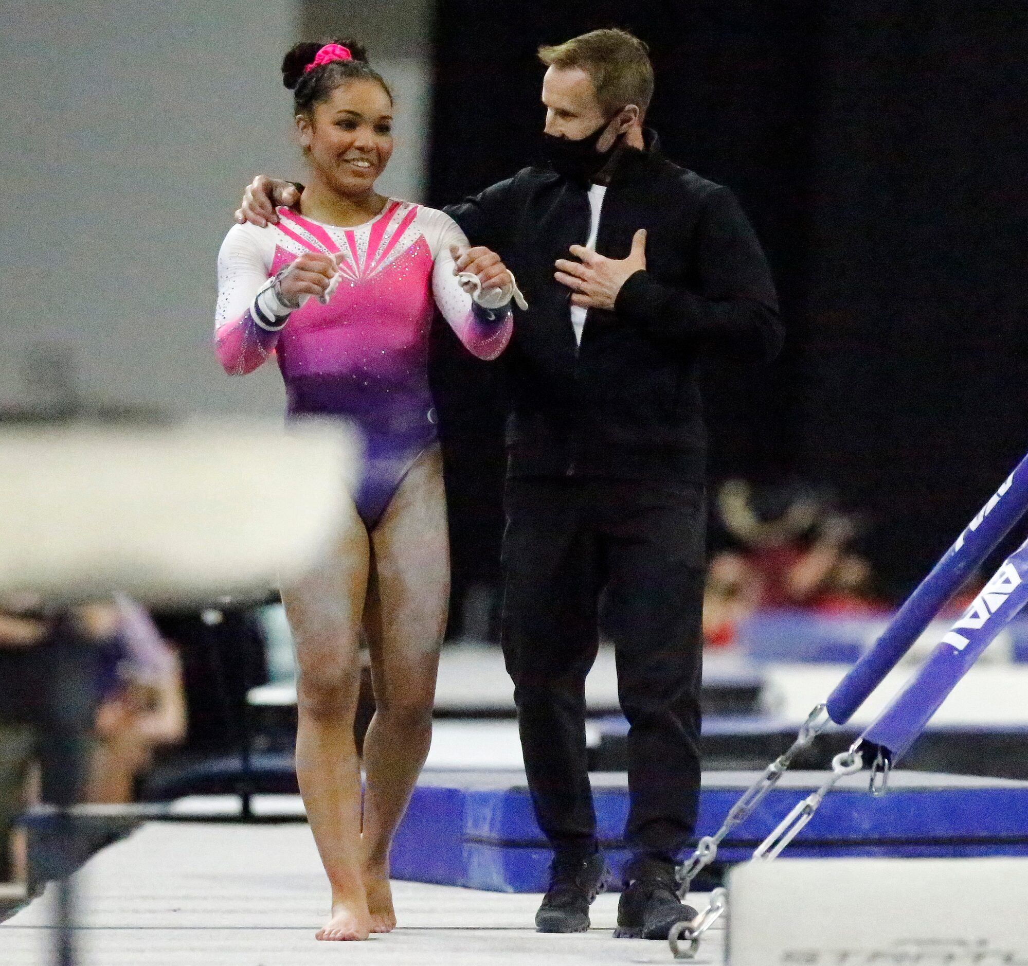 Konnor McClain (left), the eventual overall winner of WOGA Gymnastics in Plano, talks about...