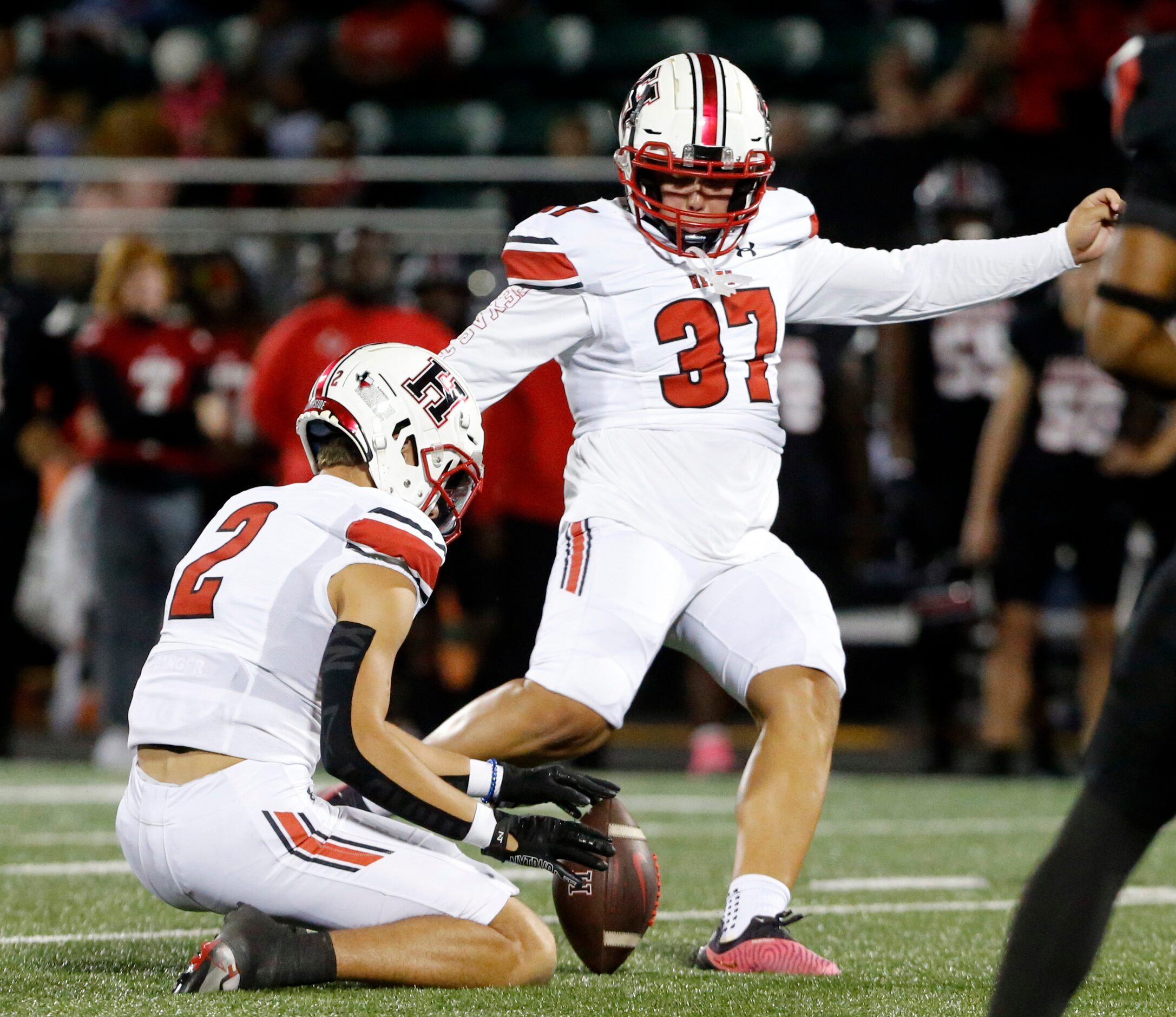 Rockwall Heath’s Bronson Mueller (37) kicks a field during the first half of a high school...