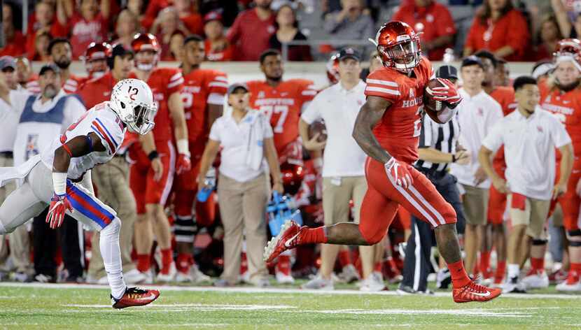 SMU defensive back Kevin Johnson (12) cannot catch Houston running back Duke Catalon (2) as...