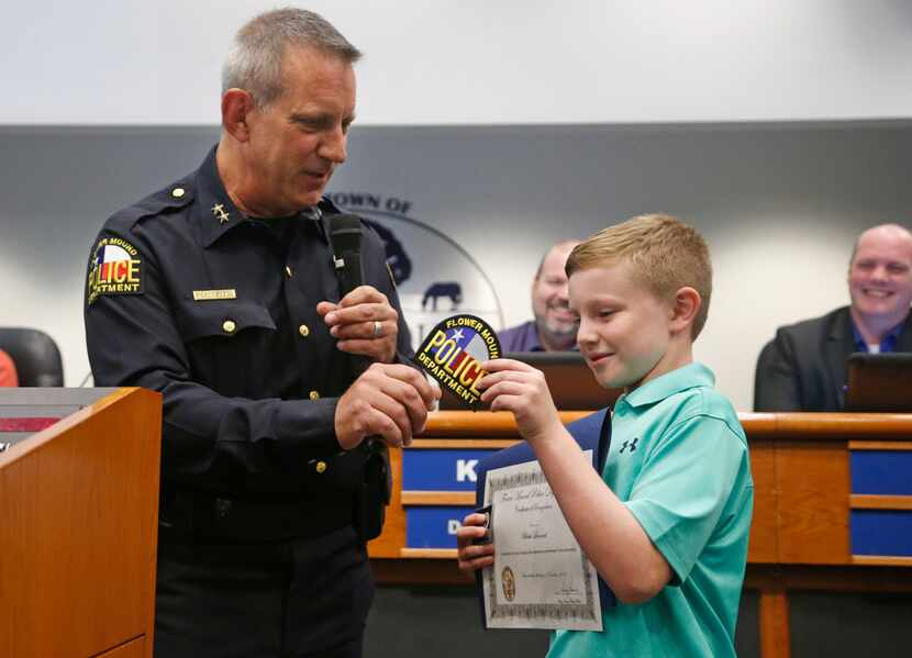 Eleven-year-old Blake Leonard of Argyle is recognized by Flower Mound Police Chief Andy...