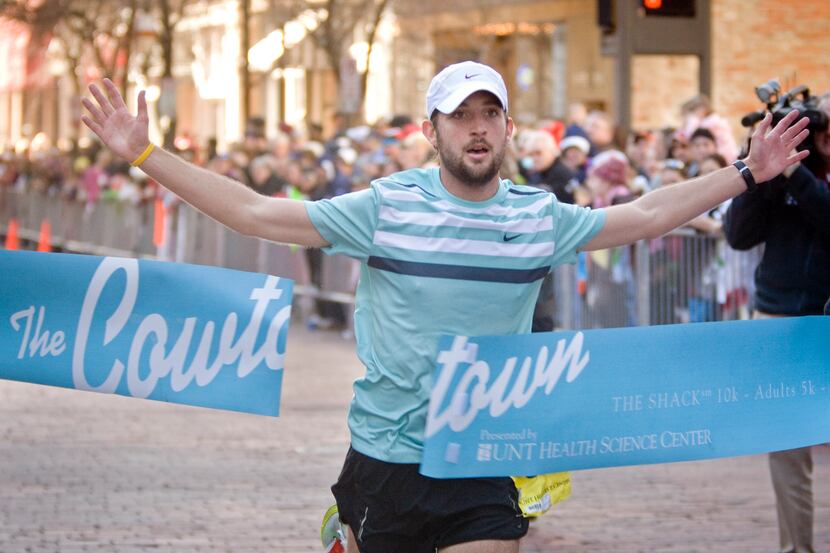 Logan Sherman crosses the finish line of the Cowtown Marathon in Fort Worth in 2010....