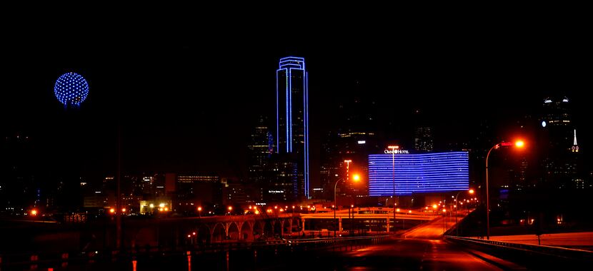 Usually outlined in green lights, the Bank of America Plaza switched to blue to honor law...
