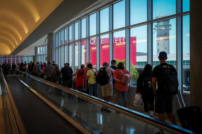 Passengers wait to re-enter Dallas Love Field Airport on July 25, 2022 after a ground stop.